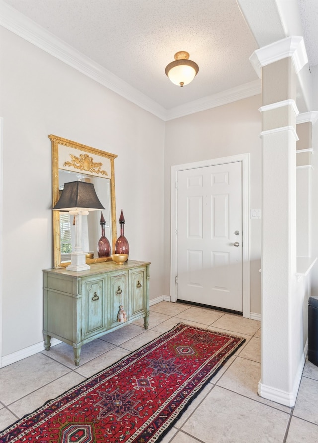 tiled foyer with crown molding and a textured ceiling