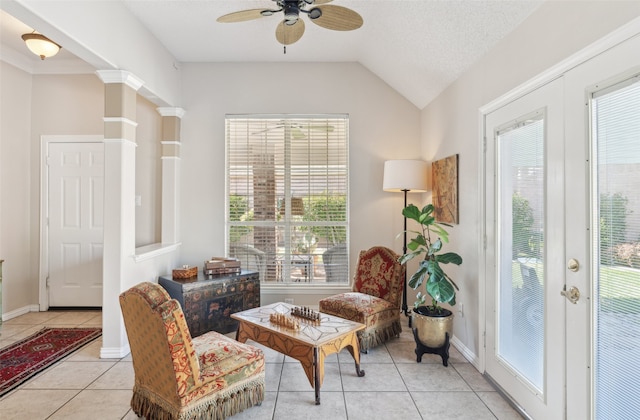 sitting room featuring a textured ceiling, vaulted ceiling, ceiling fan, and light tile patterned flooring