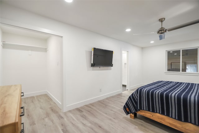 bedroom featuring ceiling fan, a closet, and light wood-type flooring