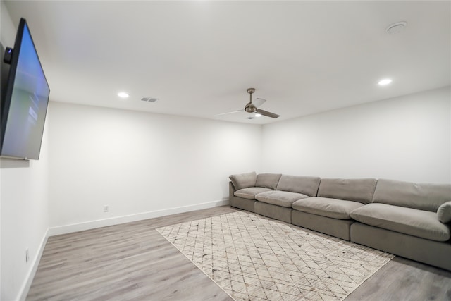 living room with ceiling fan and light hardwood / wood-style floors