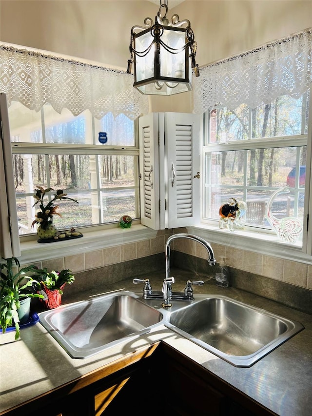 interior space with an inviting chandelier and sink