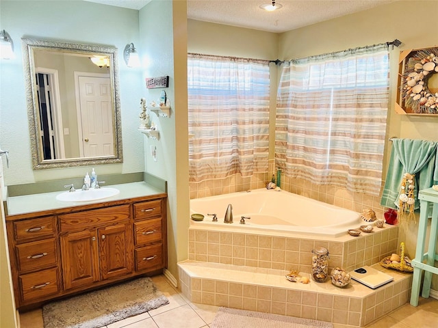 bathroom with vanity, tiled bath, tile patterned flooring, and a textured ceiling