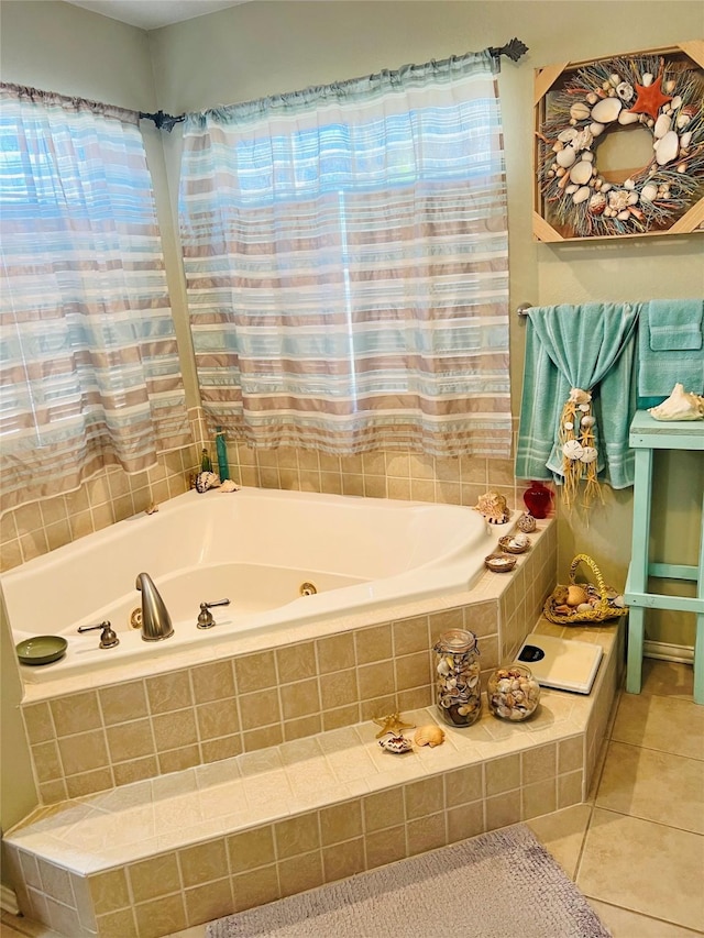 bathroom with a relaxing tiled tub and tile patterned floors