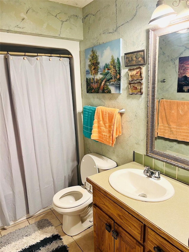 bathroom featuring tile patterned flooring, vanity, and toilet