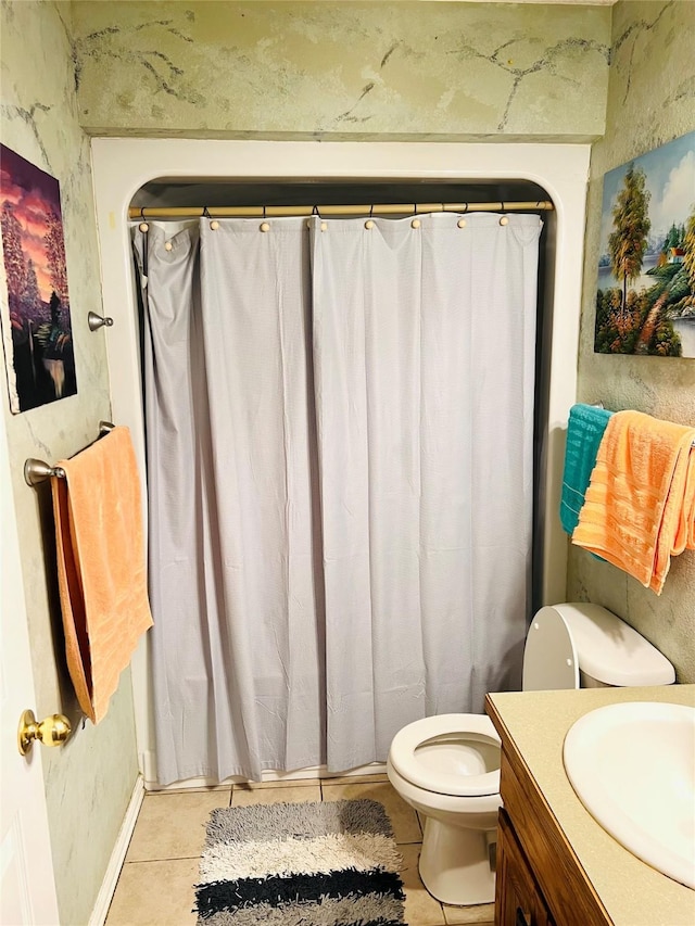 bathroom featuring vanity, toilet, and tile patterned flooring