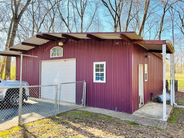 exterior space featuring a garage and an outdoor structure