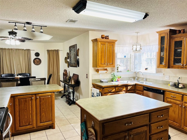 kitchen featuring sink, range, a center island, decorative light fixtures, and stainless steel dishwasher