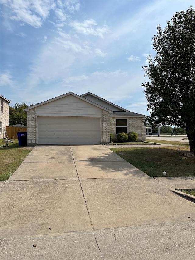 ranch-style home featuring a garage and a front yard