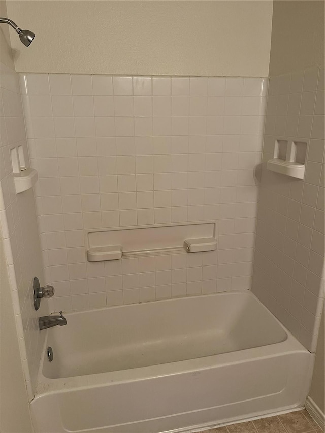 bathroom featuring tile patterned flooring and washtub / shower combination