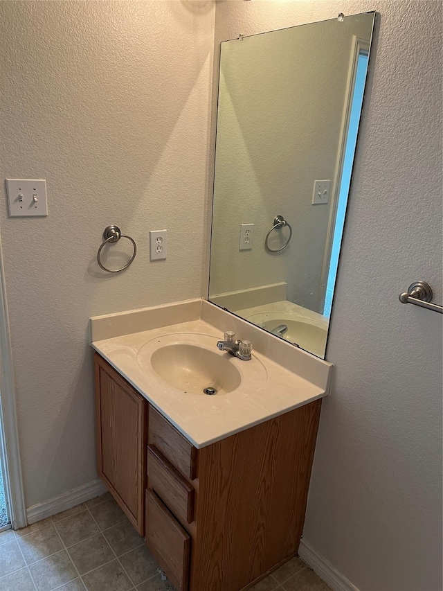 bathroom with tile patterned floors and vanity