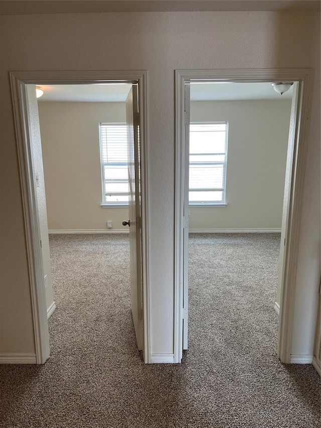 hallway with light colored carpet