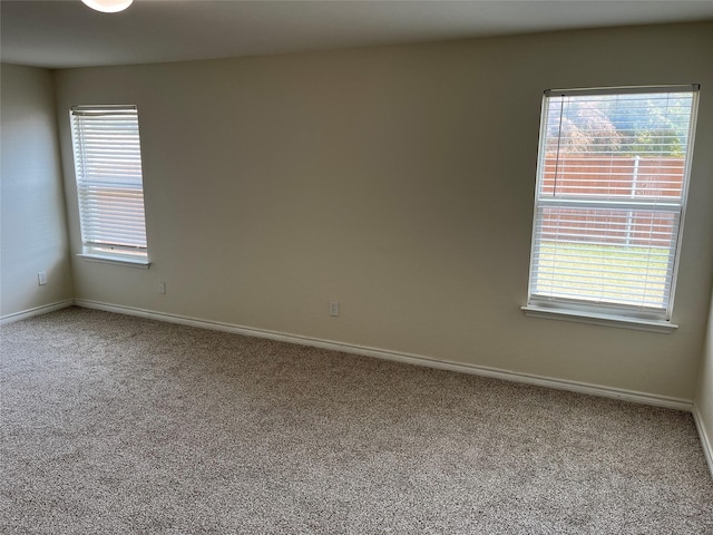 carpeted empty room featuring a healthy amount of sunlight