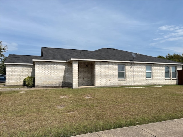 back of property featuring a lawn