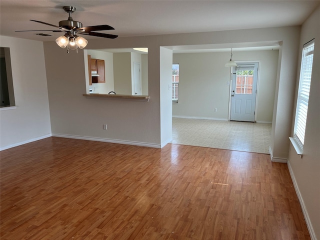 interior space with ceiling fan and wood-type flooring