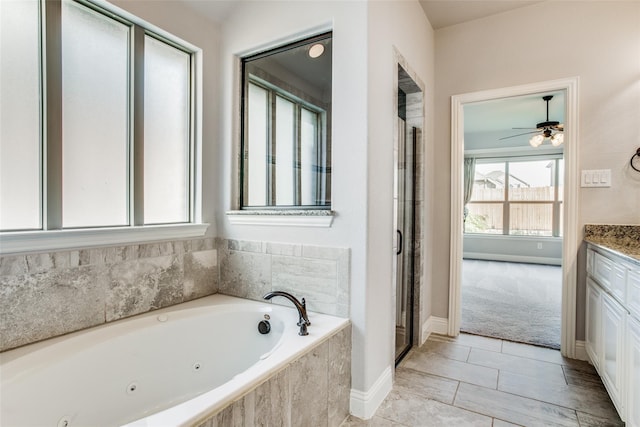 bathroom with a relaxing tiled tub and vanity