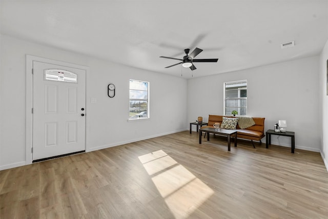 entrance foyer featuring a healthy amount of sunlight, ceiling fan, and light hardwood / wood-style flooring