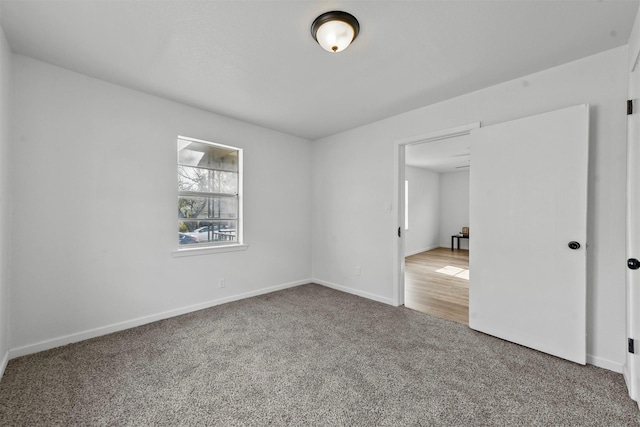 spare room with carpet floors and baseboards