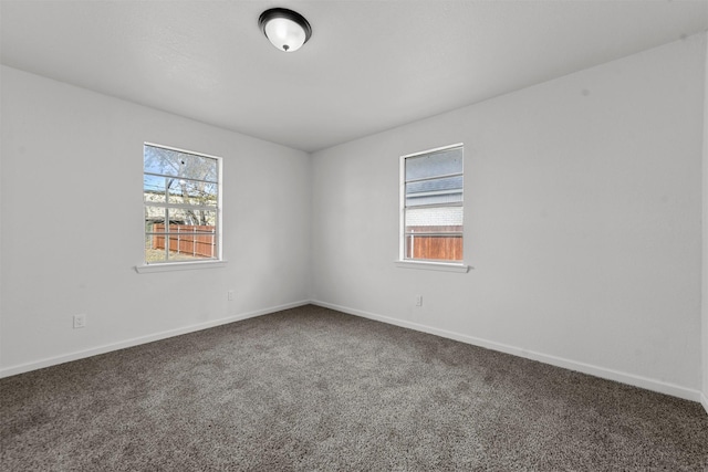 carpeted empty room with baseboards