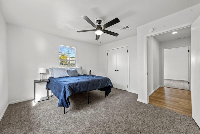 bedroom featuring a ceiling fan, baseboards, visible vents, and carpet flooring