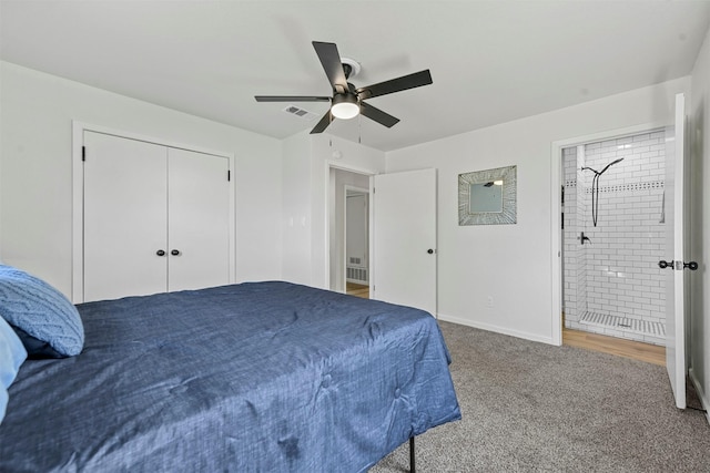 carpeted bedroom featuring baseboards, a ceiling fan, and ensuite bathroom