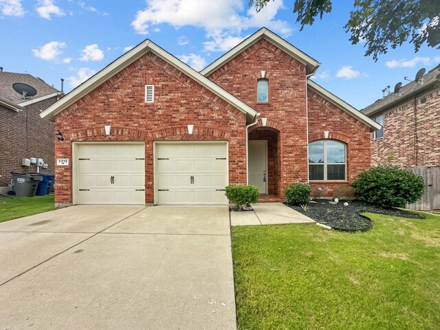 view of property featuring a garage and a front lawn