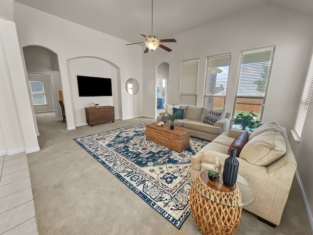 living room featuring ceiling fan, carpet floors, and vaulted ceiling