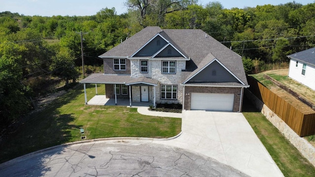 view of front of home featuring a garage, a porch, and a front yard