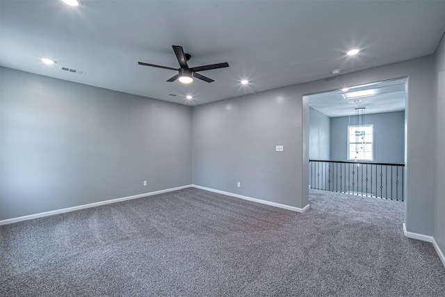 carpeted spare room featuring ceiling fan