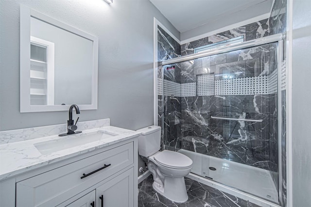 bathroom with vanity, an enclosed shower, and toilet