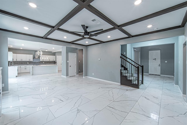 unfurnished living room with beamed ceiling, ceiling fan, and coffered ceiling