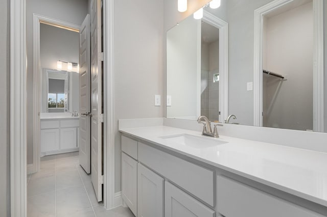 bathroom featuring tile patterned flooring and vanity