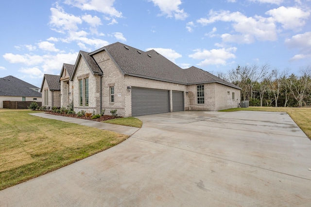 view of side of home featuring a garage and a yard