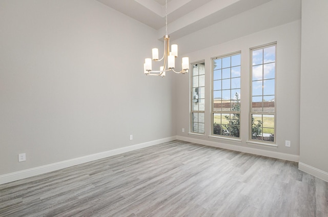 unfurnished room featuring light hardwood / wood-style floors and an inviting chandelier