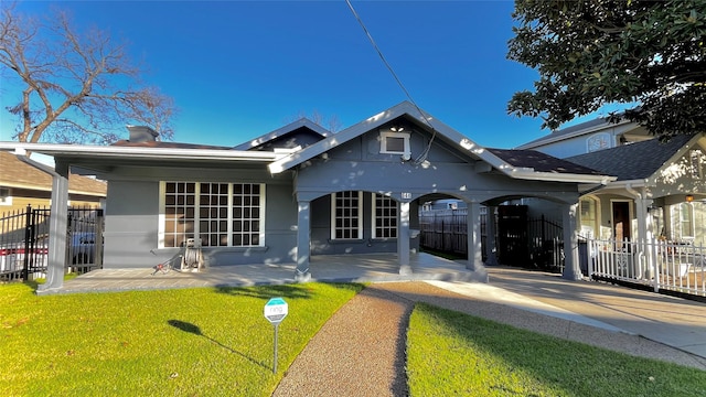 back of house with a lawn