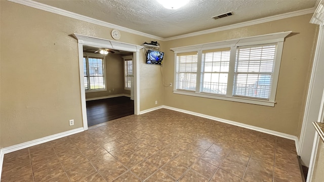 empty room featuring ceiling fan, crown molding, and a textured ceiling