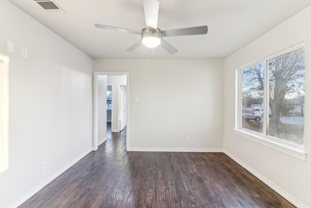 unfurnished room featuring ceiling fan and dark wood-type flooring