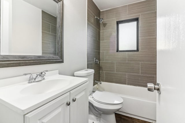 full bathroom with vanity, toilet, and tiled shower / bath