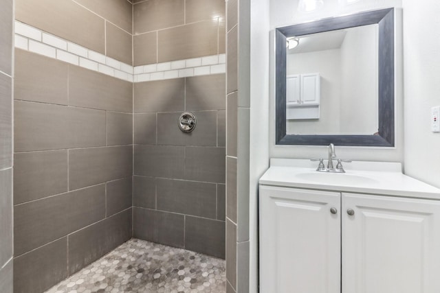 bathroom with vanity and a tile shower