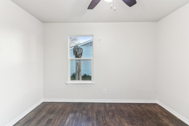 spare room with ceiling fan and dark wood-type flooring