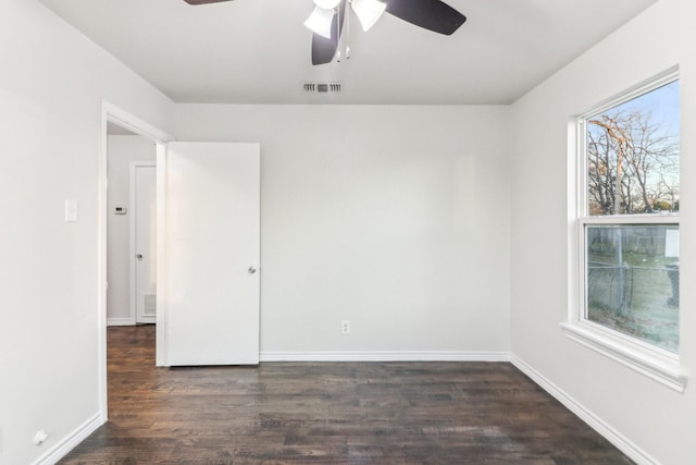 empty room featuring ceiling fan and dark hardwood / wood-style flooring