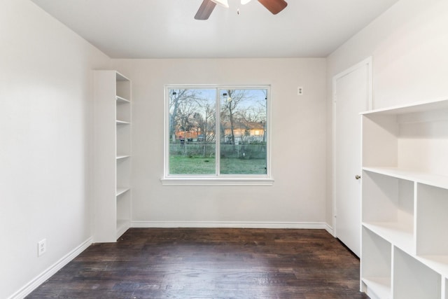 unfurnished room featuring ceiling fan and dark wood-type flooring