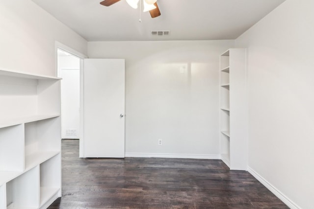 spare room with dark hardwood / wood-style flooring and ceiling fan