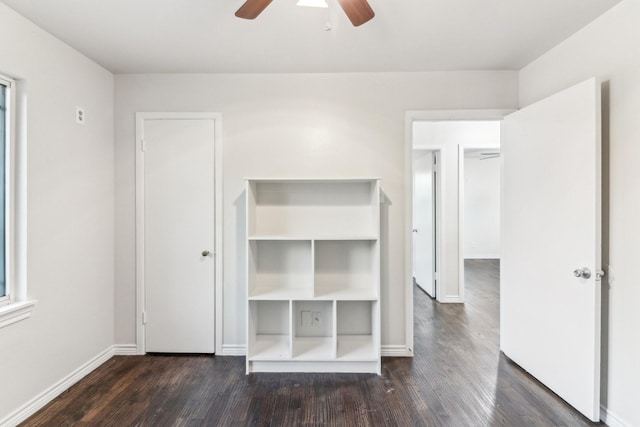 unfurnished bedroom with dark hardwood / wood-style floors and ceiling fan