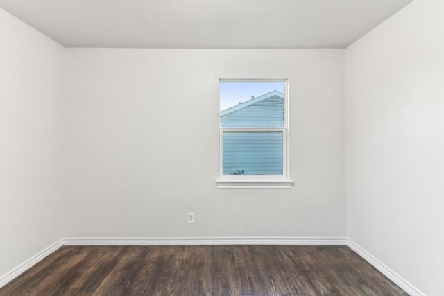 empty room with dark hardwood / wood-style floors