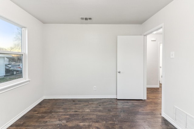 empty room featuring dark hardwood / wood-style flooring