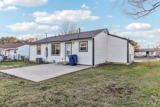 rear view of house featuring central AC, a patio area, and a lawn