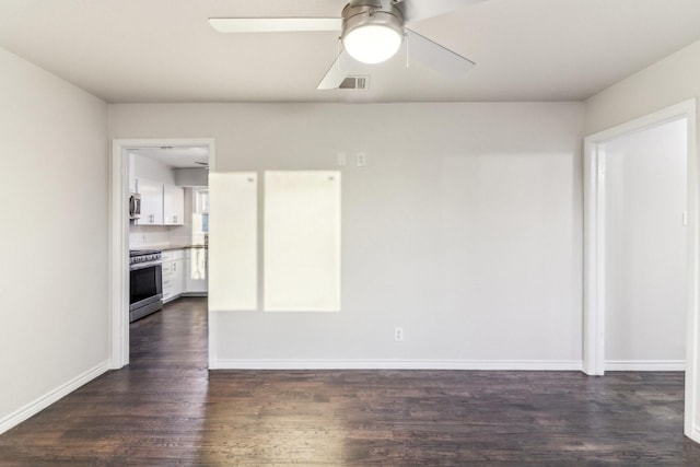 empty room with ceiling fan and dark wood-type flooring