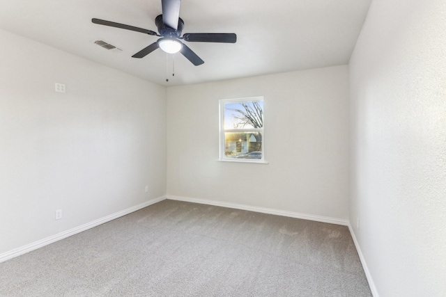 carpeted empty room featuring ceiling fan