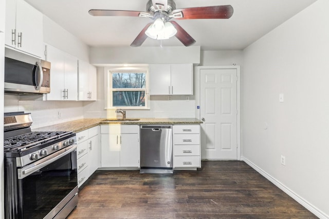 kitchen with white cabinetry, appliances with stainless steel finishes, and tasteful backsplash