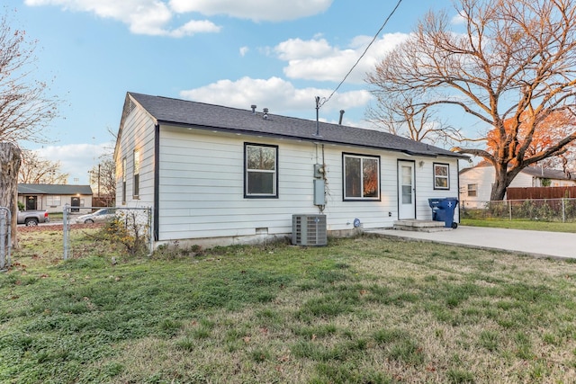 view of front of home with central AC, a front lawn, and a patio area